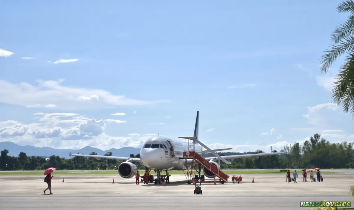 Disembarking onto the open-air tarmac at Nan Nakhon Airport under clear northern skies