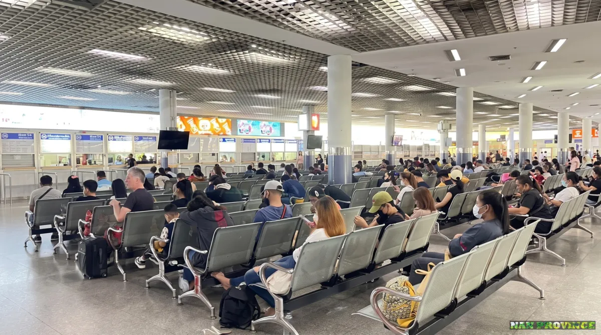 Navigating the bustling ticket hall and departure gates at Bangkok's Mochit 2 bus terminal.