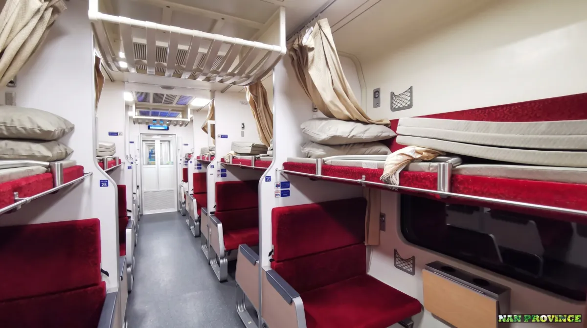 The cozy second-class air-conditioned sleeper berth with fresh sheets and privacy curtains.